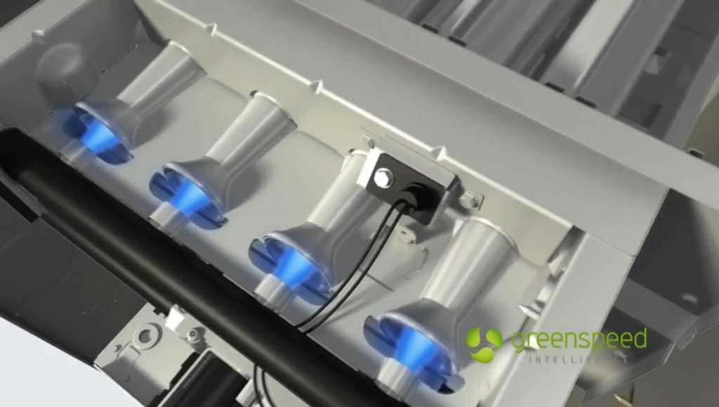 Gas furnace burners with blue flames, Greenspeed logo.