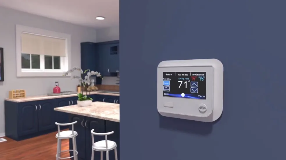 Smart thermostat mounted on blue kitchen wall.